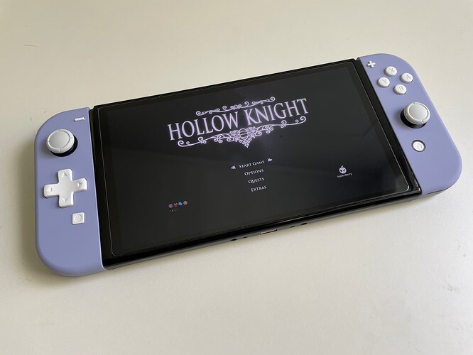 Violet Joy-Con shell with white buttons and D-Pad attached to a Nintendo Switch